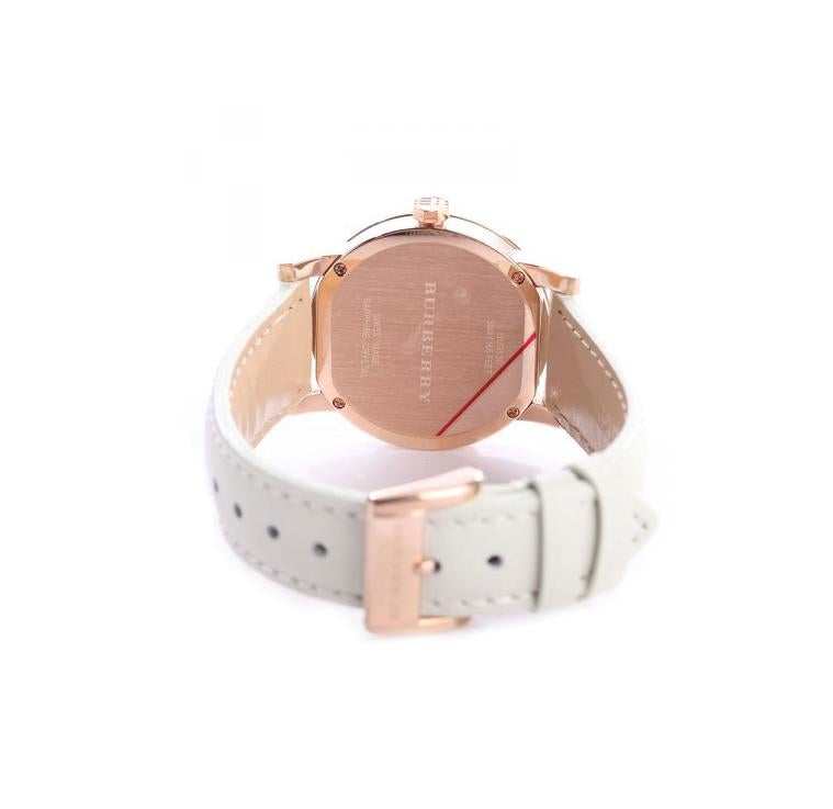 Burberry The City watch caseback showing rose gold case and white leather strap