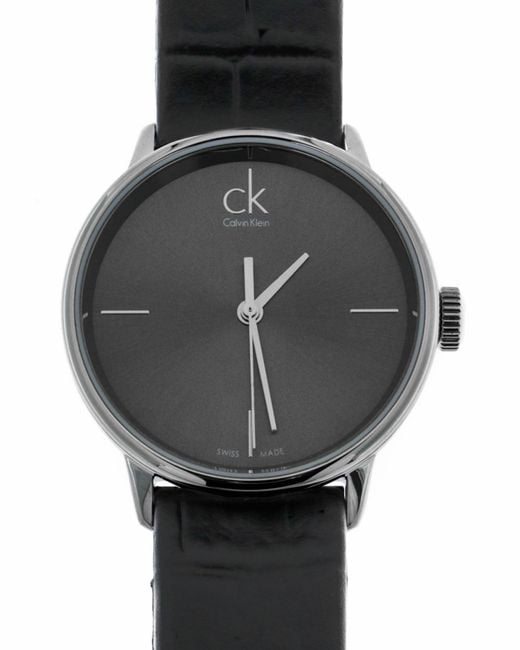 Calvin Klein Accent watch face showing minimalist design with center and hour markers on charcoal dial