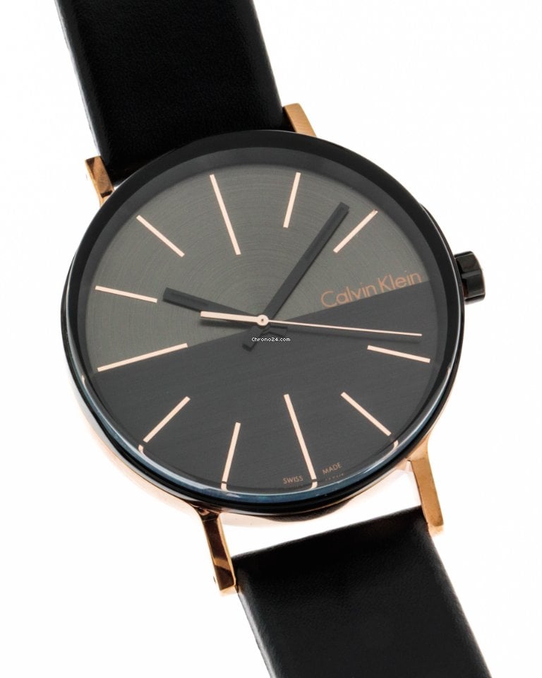 Calvin Klein Boost men's watch on wrist displaying black dial with rose gold markers and indices