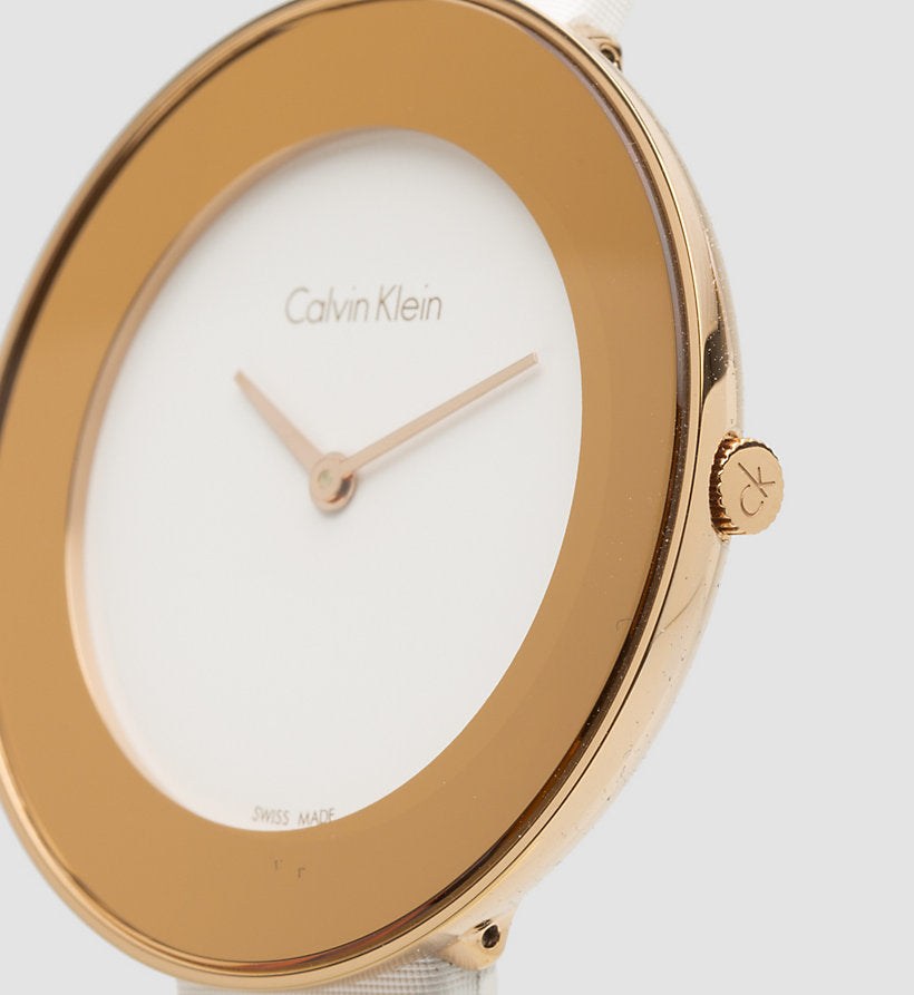 Close-up of Calvin Klein Chic watch dial showing rose gold bezel and minimalist white face