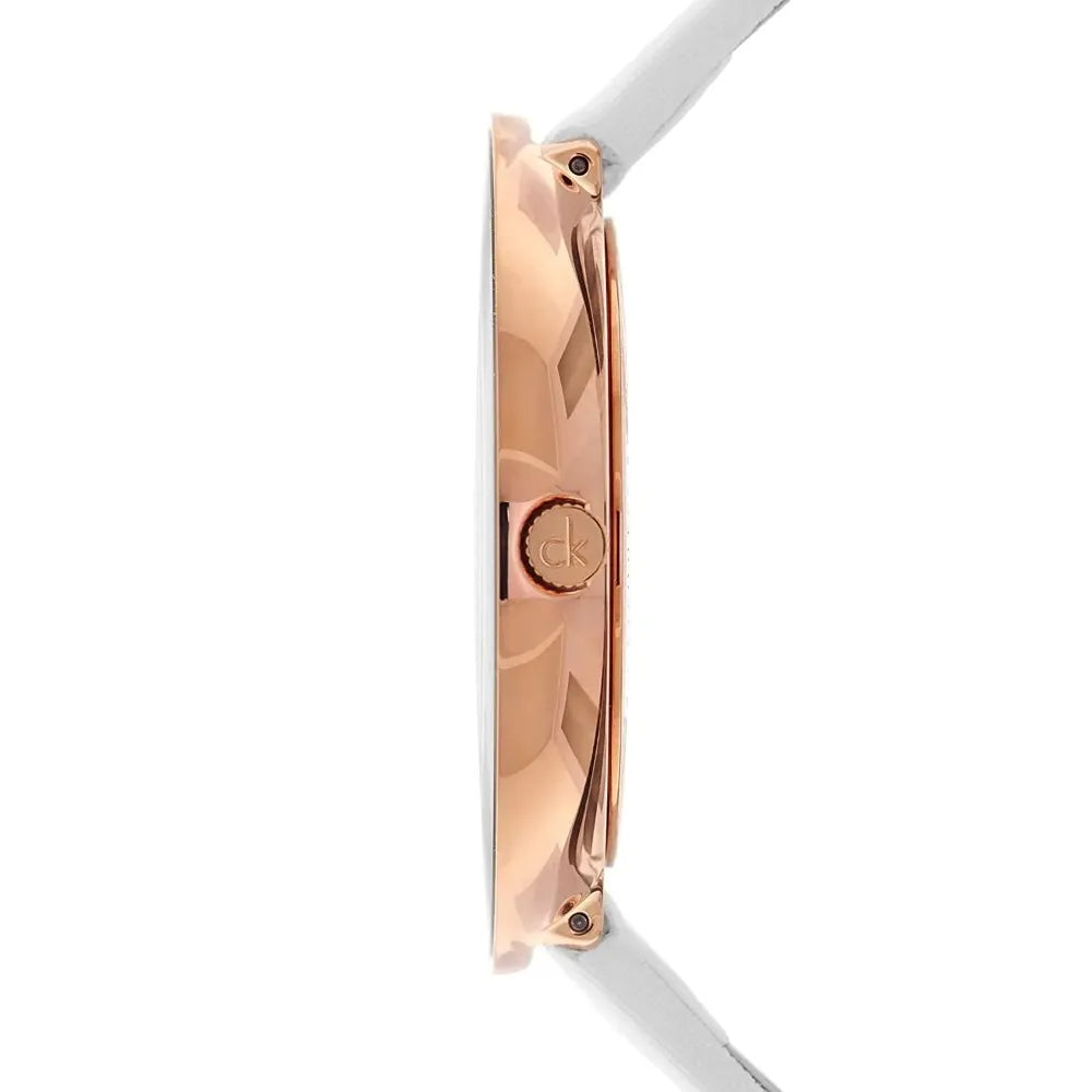 Side view of Calvin Klein Chic watch showing rose gold case profile with white leather strap