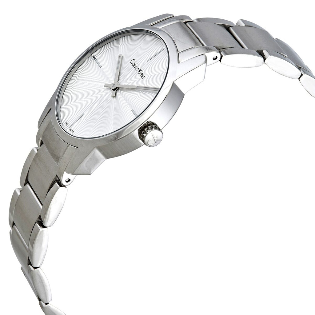 Calvin Klein City women's watch on wrist showing silver steel bracelet and white dial