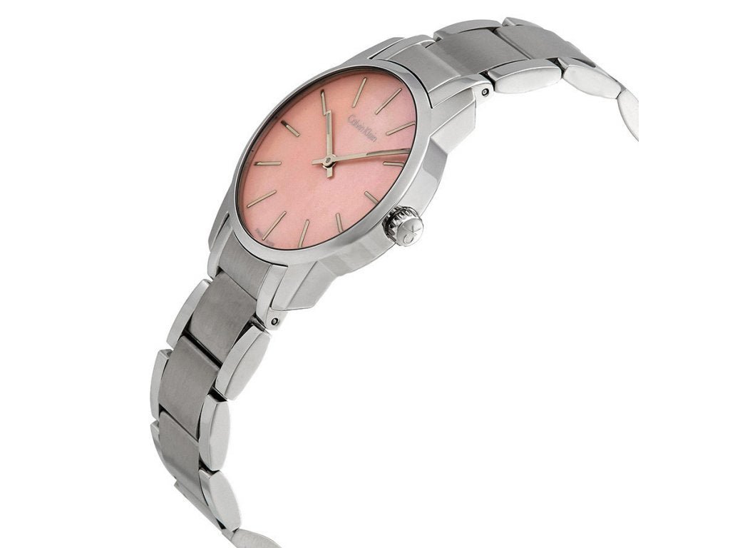 Calvin Klein City watch worn on wrist, displaying pink mother-of-pearl dial with minimalist design