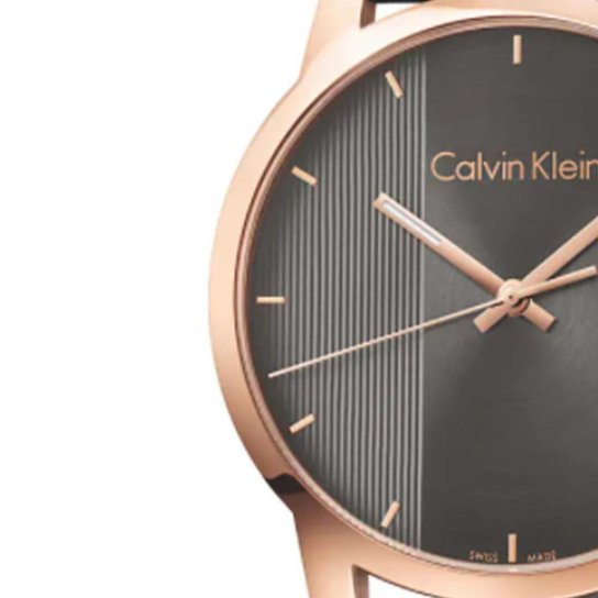 Close-up of ebony black dial with vertical texture, rose gold-tone hands and indices, Calvin Klein branding