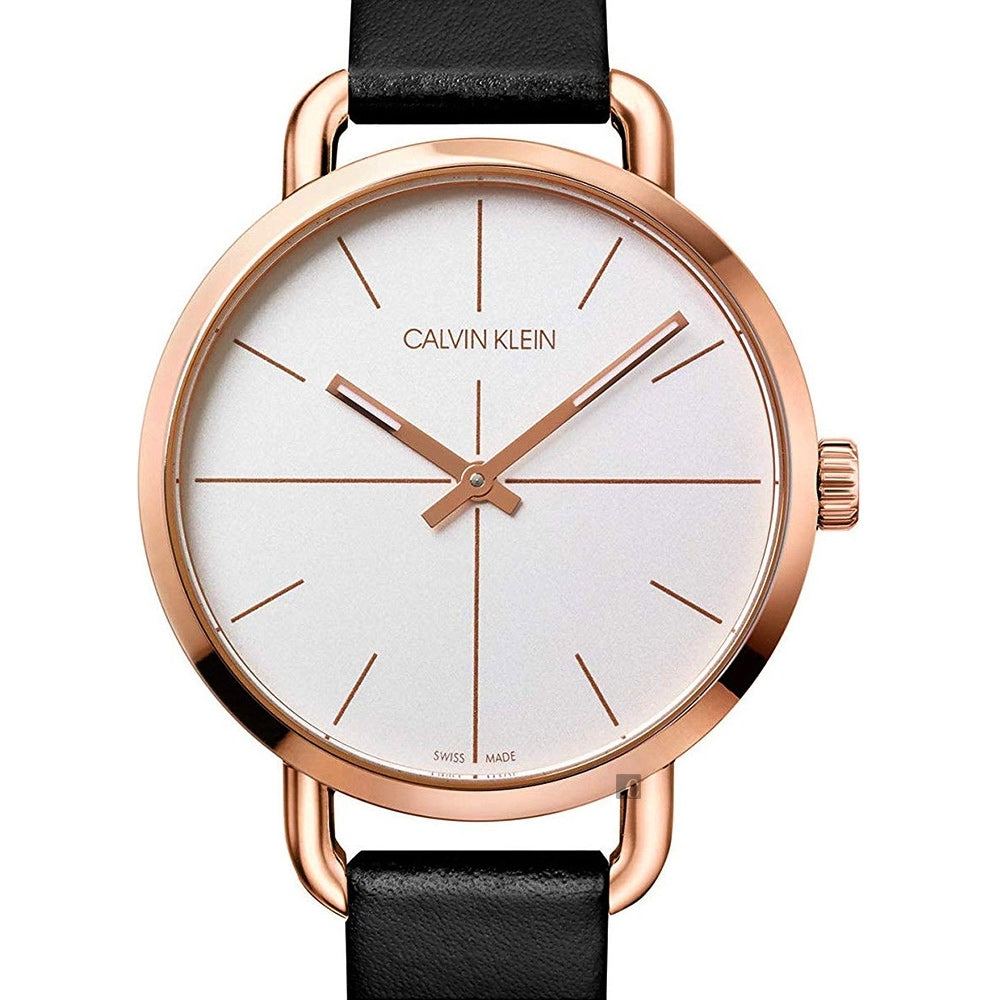 Close-up of Calvin Klein Even watch dial with rose gold hands and hour markers on silver background