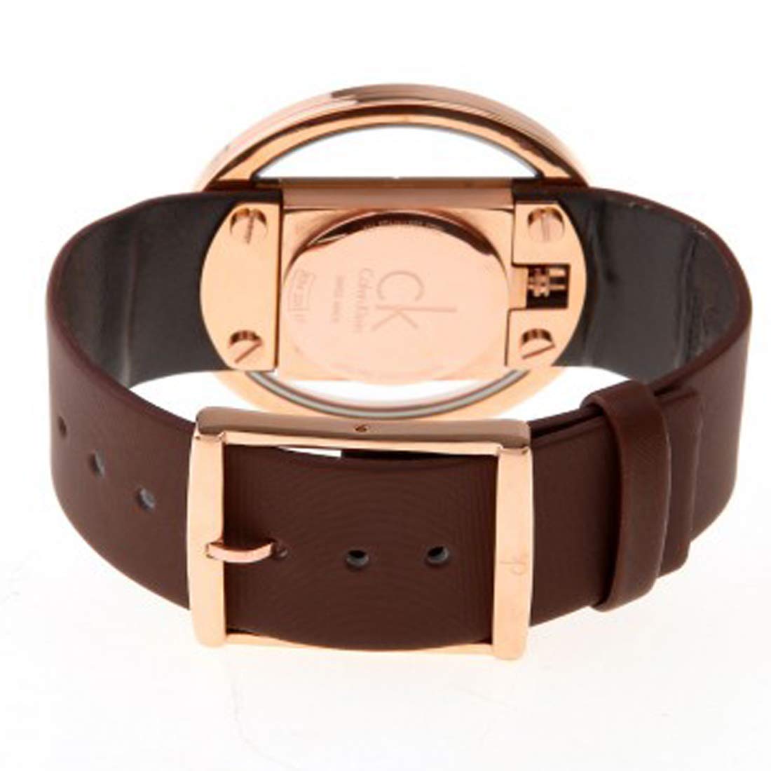 Caseback view of Calvin Klein Glam watch showing rose gold case back and brown leather strap
