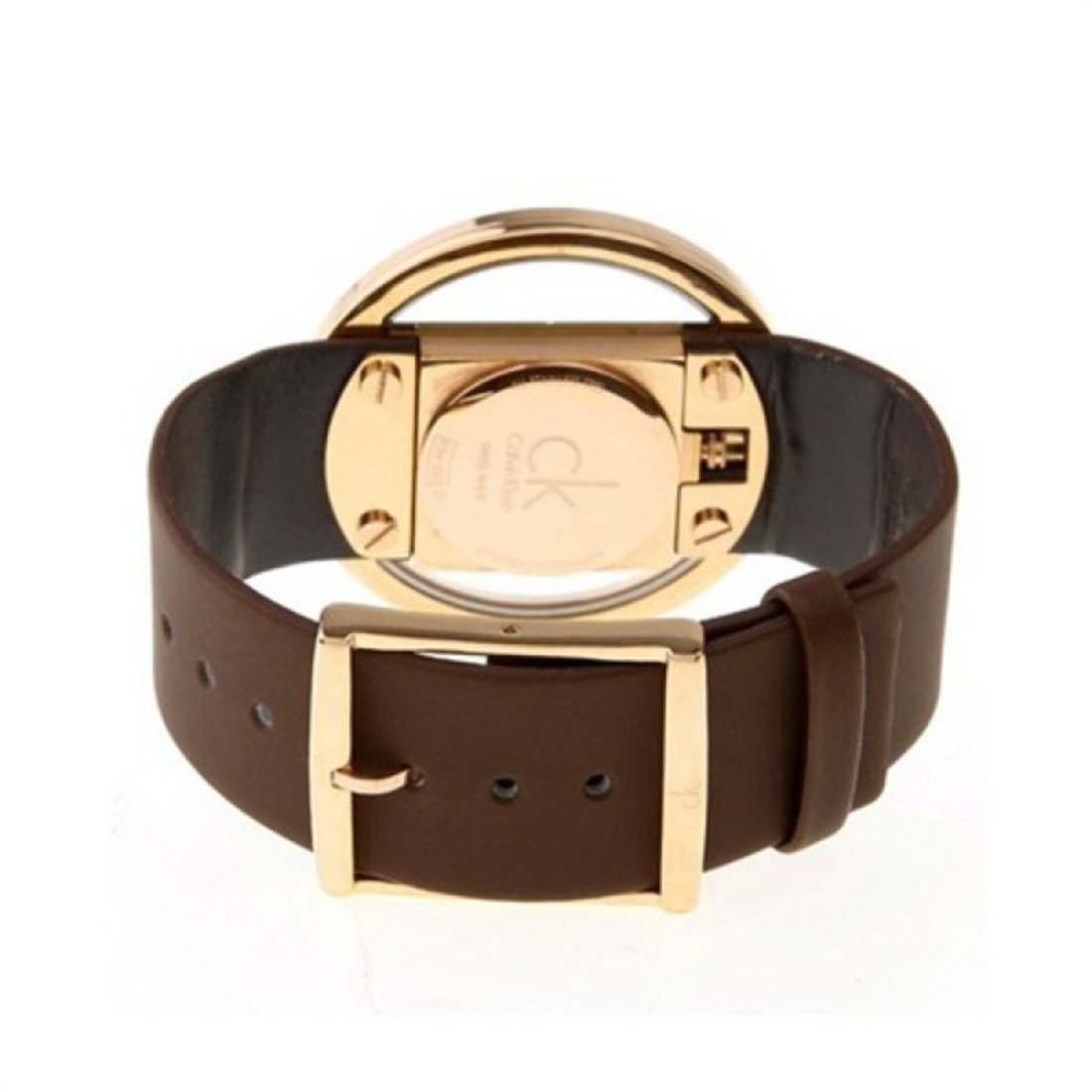Caseback of Calvin Klein Glam watch showing gold case and brown leather strap fastening