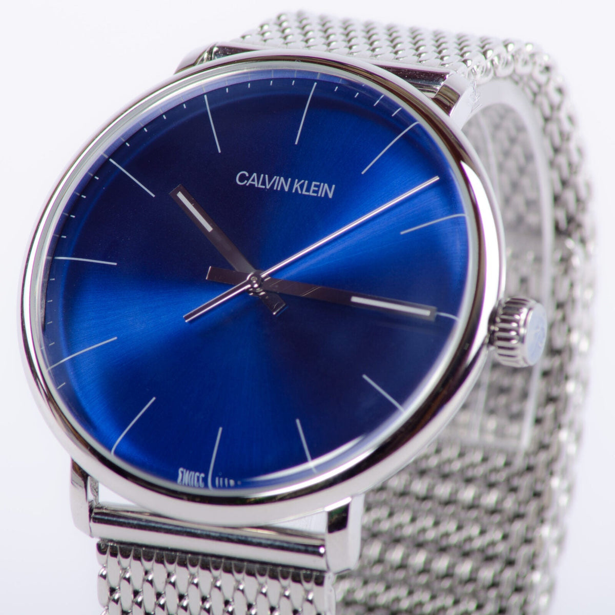 Calvin Klein High Noon K8M2112N watch showing blue sunburst dial at angle with mesh bracelet