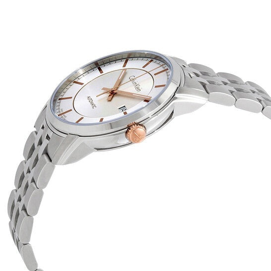 Calvin Klein Infinite automatic watch worn on wrist showing silver dial with rose gold crown and steel bracelet