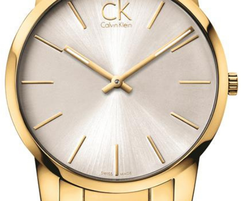 Close-up of Calvin Klein K2G21546 dial showing silver face, gold hour markers, and CK logo