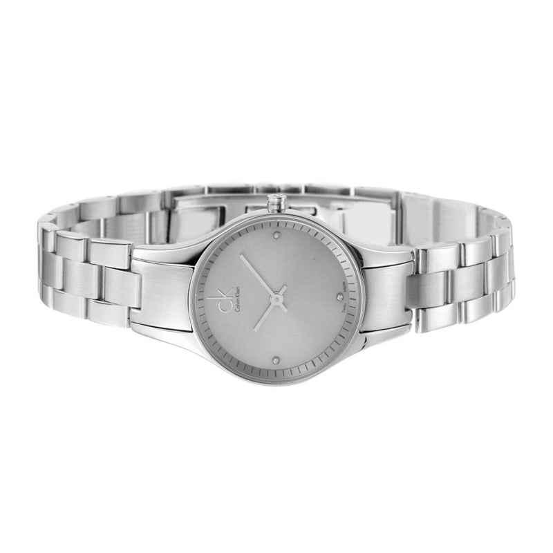 Calvin Klein Simplicity women's watch on wrist showing silver dial and steel bracelet