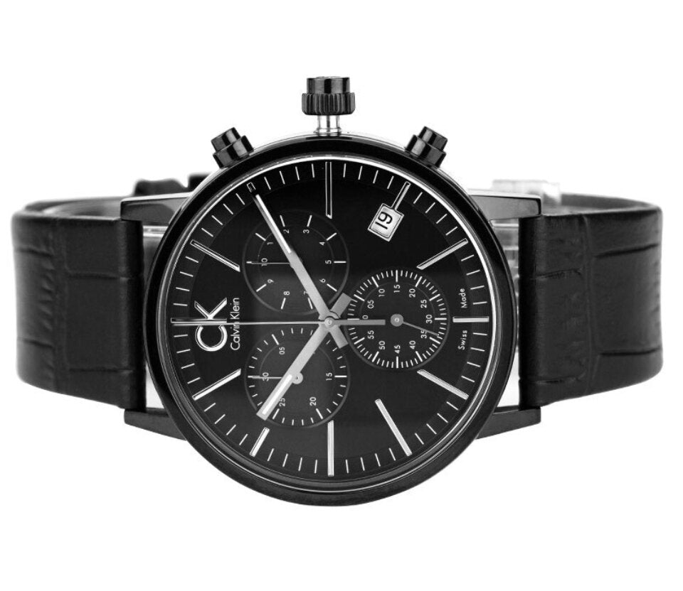 Black chronograph watch on wrist showing full strap and case design