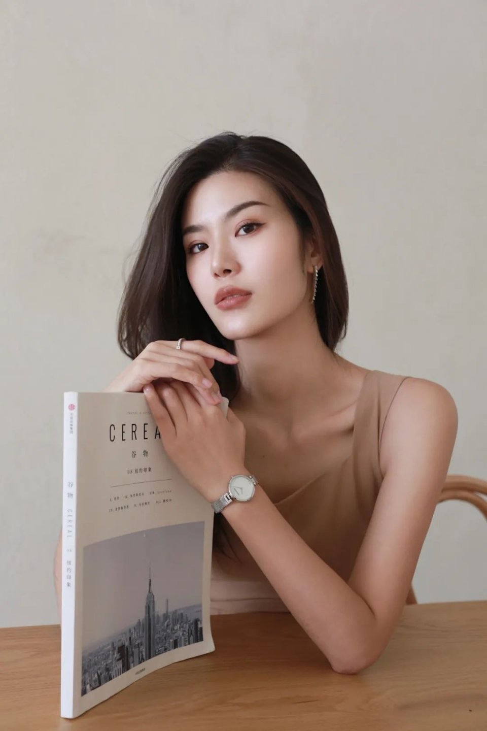 Woman wearing Calvin Klein K8G2312E watch with silver mesh band and white dial