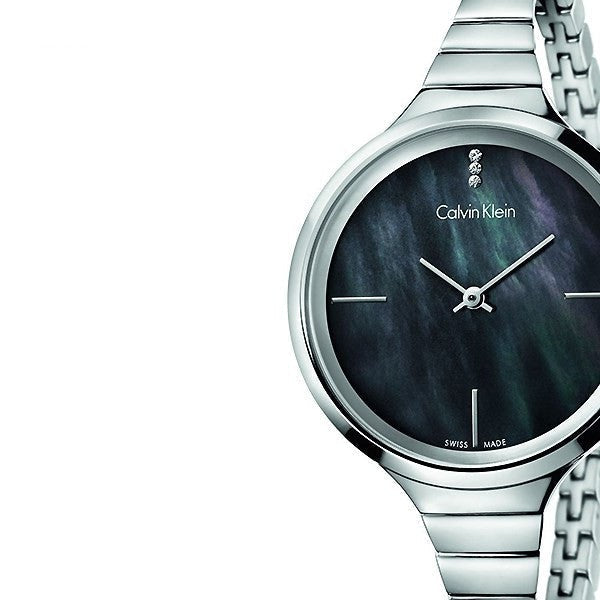Close-up of Calvin Klein LIVELY black pearl dial with silver hands and indices