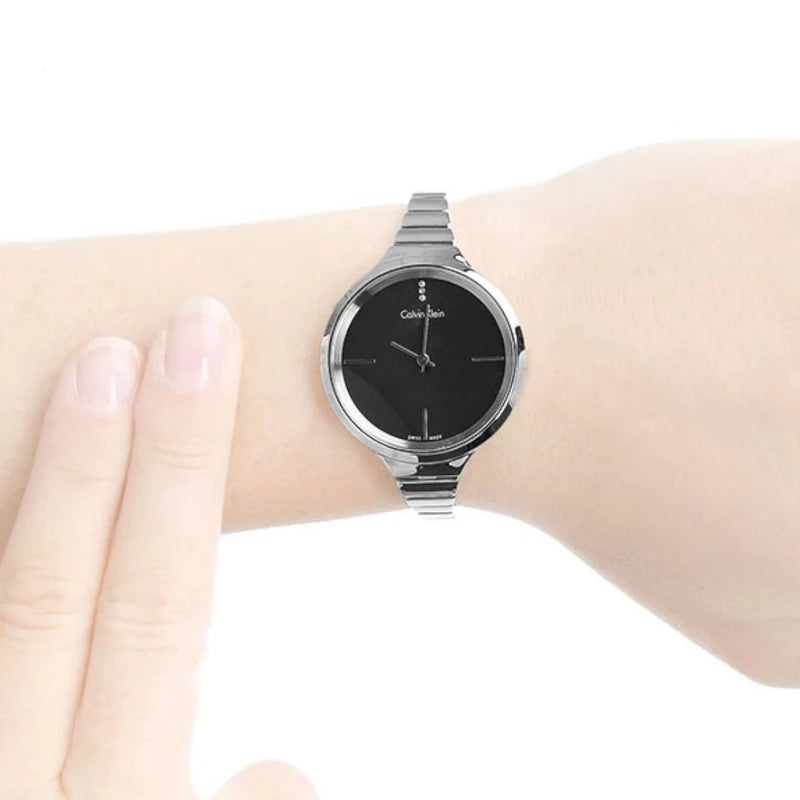 Calvin Klein LIVELY watch worn on wrist, black dial with steel bracelet