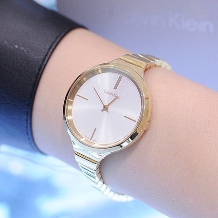 Calvin Klein Lively K4U23526 gold watch worn on wrist showing silver dial and gold bracelet