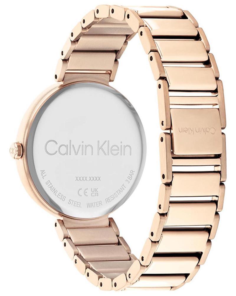 Calvin Klein Minimalistic watch caseback showing engraved dial and gold-tone stainless steel bracelet