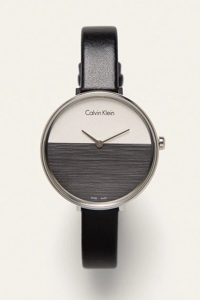 Calvin Klein Rise watch worn on wrist showing split dial with white upper and gray lower half