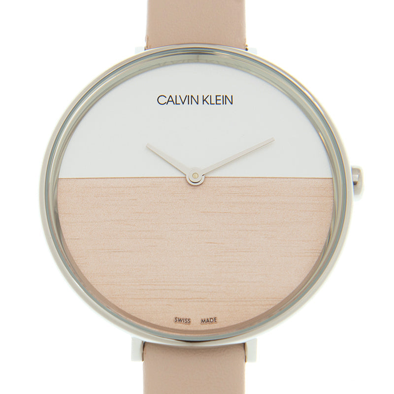 Calvin Klein Rise watch dial detail showing split design with wood texture