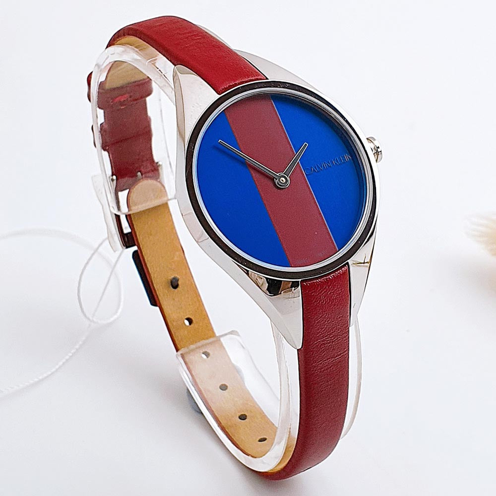 Three-quarter view of Calvin Klein Rise K8P231UN showcasing case profile and burgundy leather strap detail
