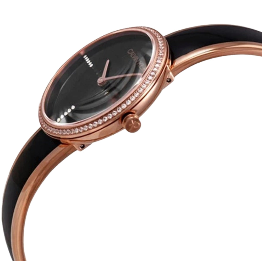Side angle view of Calvin Klein Seduce watch showing rose gold case and black leather strap