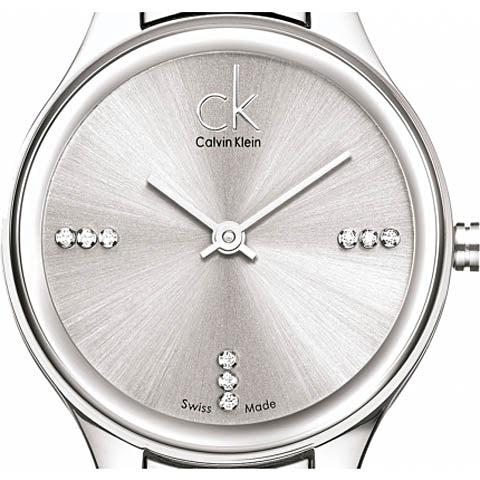 Close-up of Calvin Klein Simplicity dial with crystal hour markers and Swiss Made marking