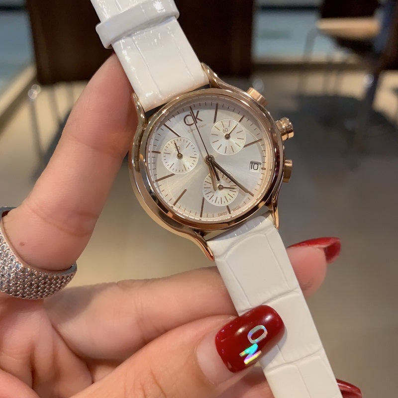 Calvin Klein Skirt chronograph watch held in hand, white leather strap and rose gold case