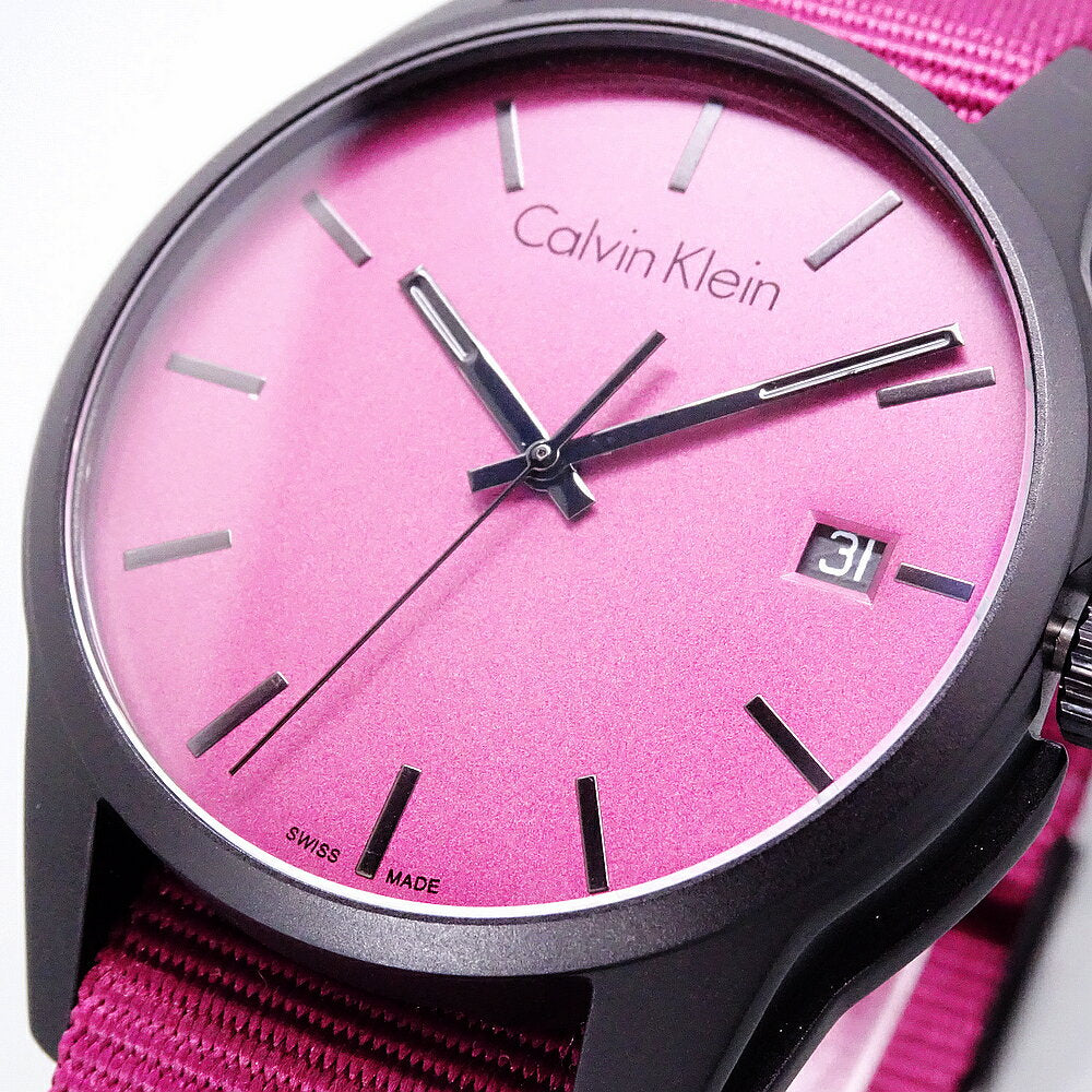 Calvin Klein Tone Collection K7K514UP dial detail with pink-toned face and black hands on hot pink strap