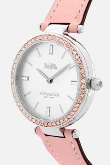 Coach watch angled view showing pink strap and crystal-set bezel detail