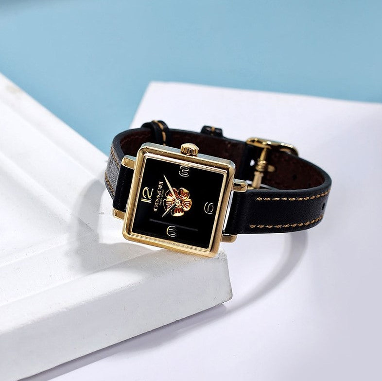 Coach black leather square watch worn on wrist with gold case