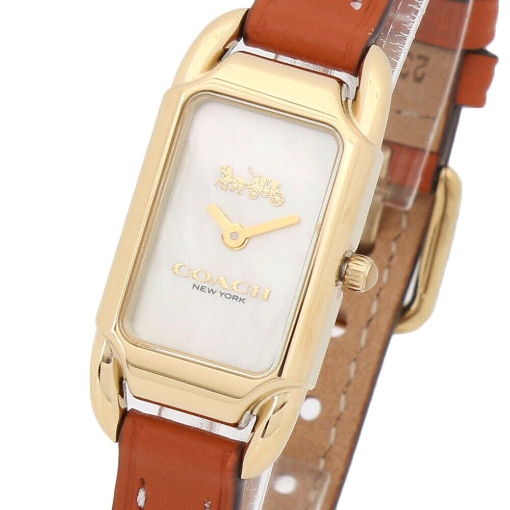 Coach Cadie watch face showing ivory mother-of-pearl dial with gold hands and Coach logo