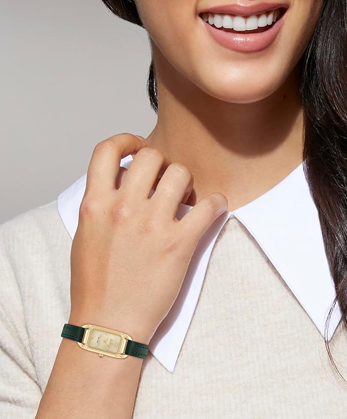 Coach Cadie watch worn on wrist showing green leather strap and gold-tone rectangular case