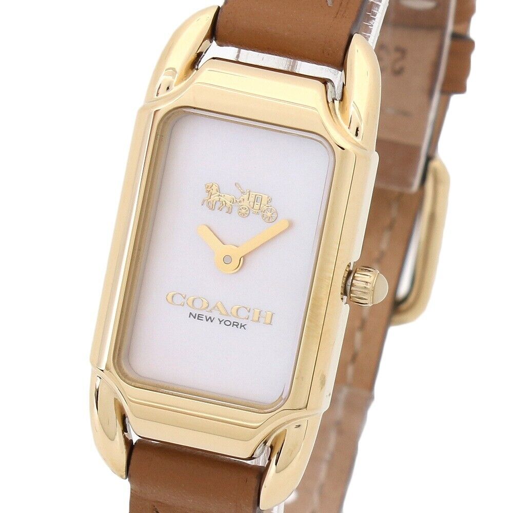 Close-up of Coach Cadie watch dial showing Coach logo, gold-tone hands, and lavender face