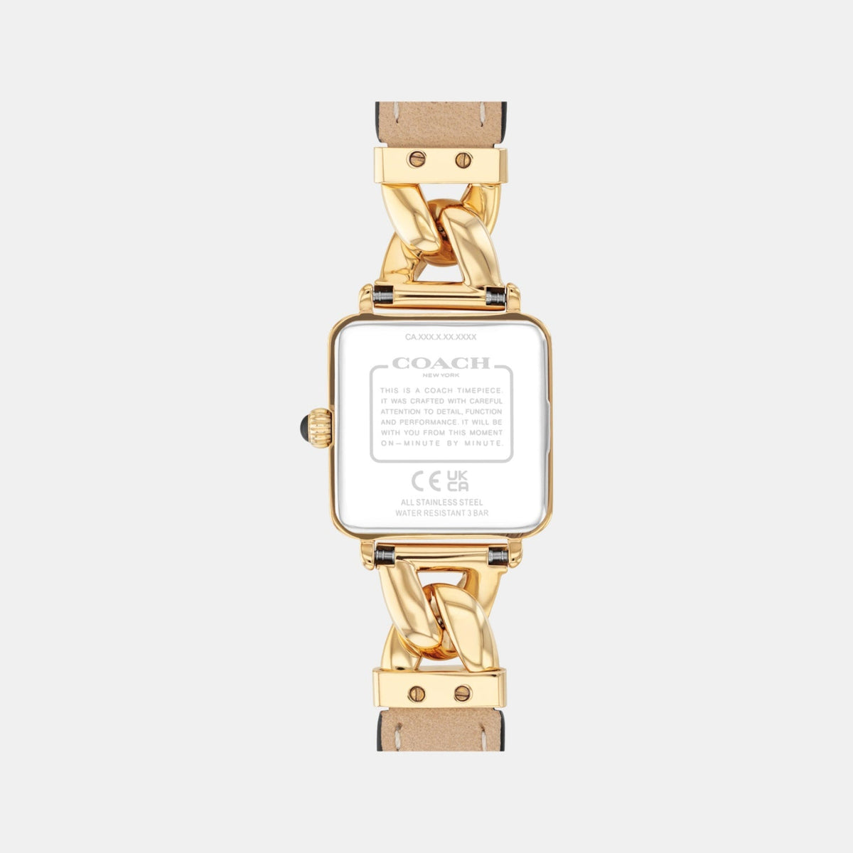 Caseback of Coach Cass watch displaying gold-tone case back with Coach branding and chain link connector