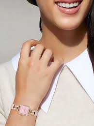 Coach Cass blush watch worn on wrist showing square case and pink calf leather strap