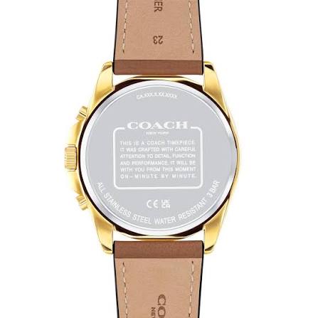 COACH Charles watch caseback with stainless steel engraving and brown leather strap visible