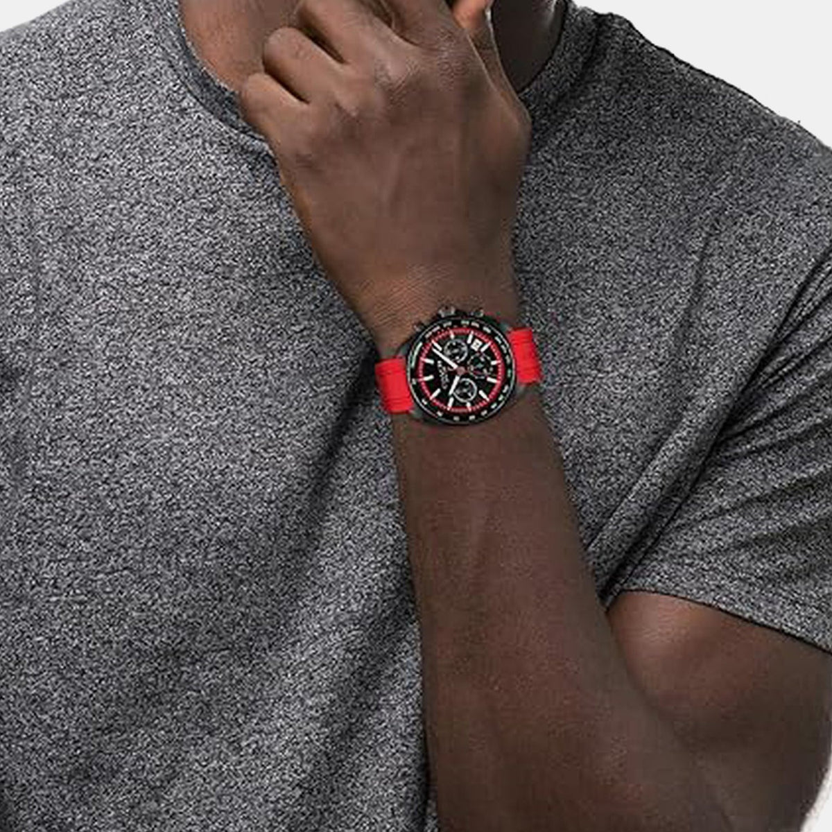 Coach Charter watch worn on wrist with red strap and black chronograph case