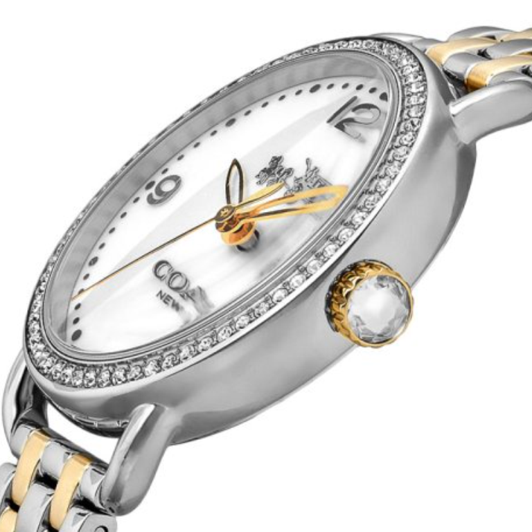 Coach Delancey watch angled side view displaying crystal bezel, two-tone bracelet, and white dial with gold hands