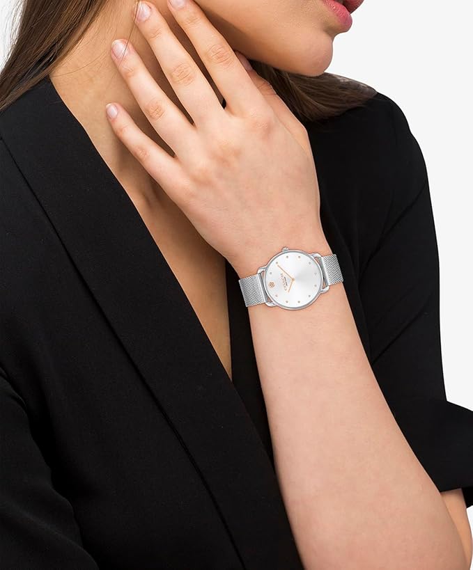 Coach Elliot women's watch worn on wrist with white dial and mesh bracelet