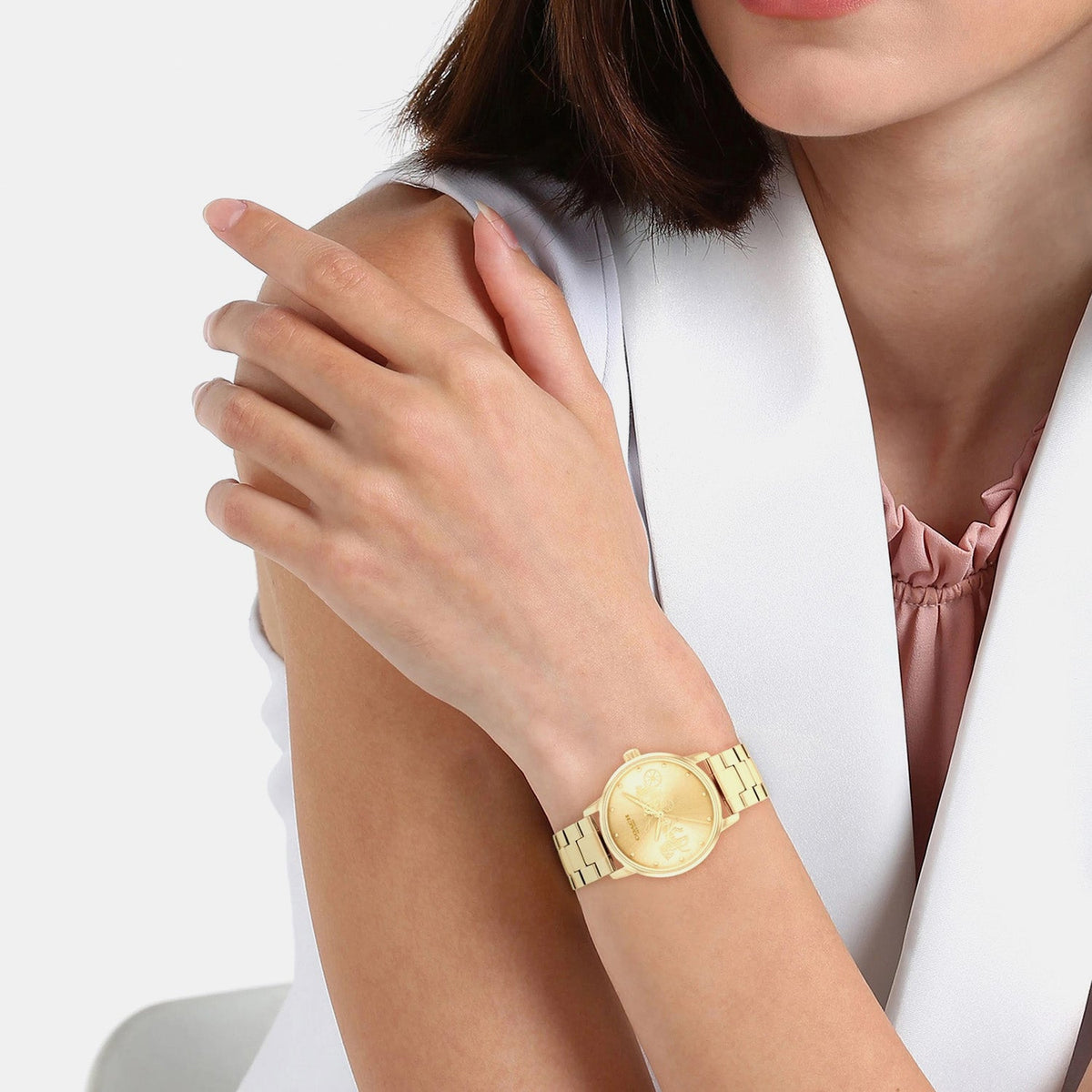 Coach Grand gold ladies watch worn on wrist with gold-tone bracelet