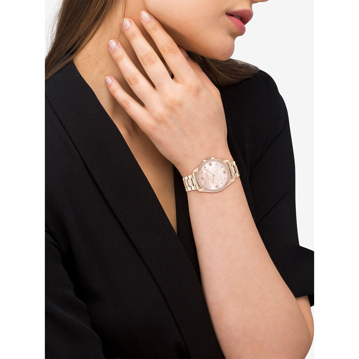 COACH Greyson rose gold watch worn on woman's wrist