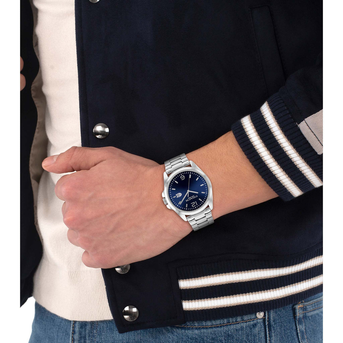 Coach Greyson watch worn on wrist with navy dial and stainless steel bracelet