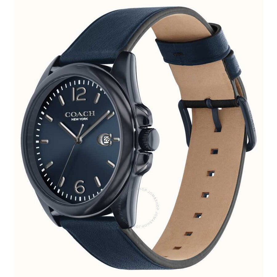 Coach Greyson watch displayed at angle showing blue dial, case, and tan leather strap with blue topstitching