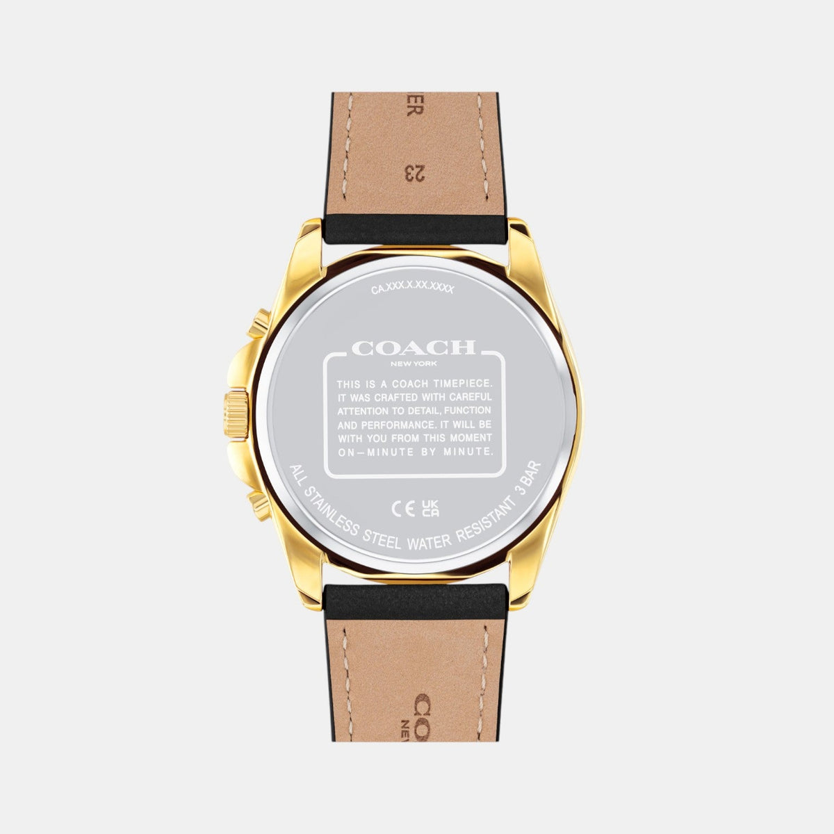 COACH Greyson watch caseback showing gold-tone steel back with engraved COACH branding and specifications