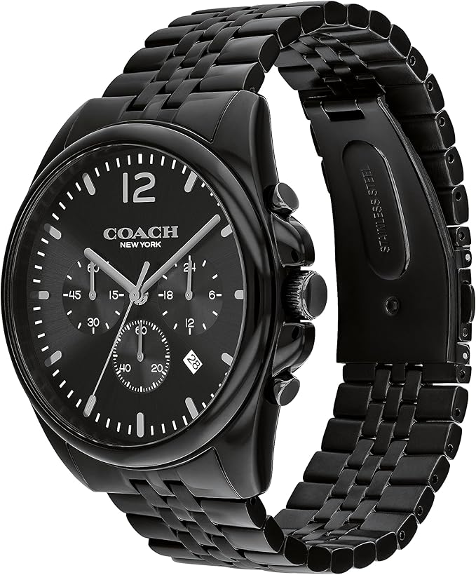 COACH Greyson watch on wrist showing black dial, chronograph subdials, and stainless steel bracelet