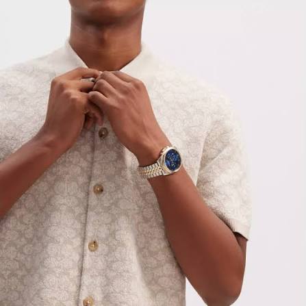 COACH Greyson chronograph watch worn on wrist with blue dial