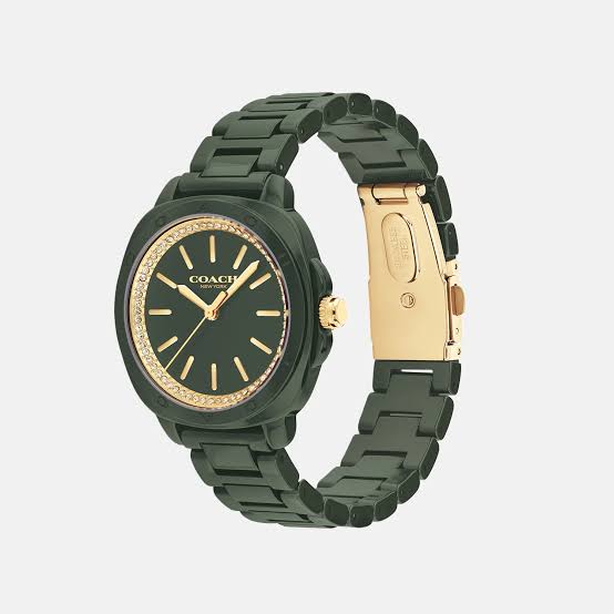 Coach Kitt watch at angle showing green ceramic bracelet, gold-tone clasp, and crystal-set bezel detail