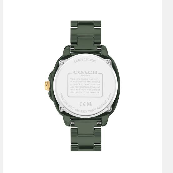 Coach Kitt watch caseback showing white dial backing, model number, and specifications on green ceramic case