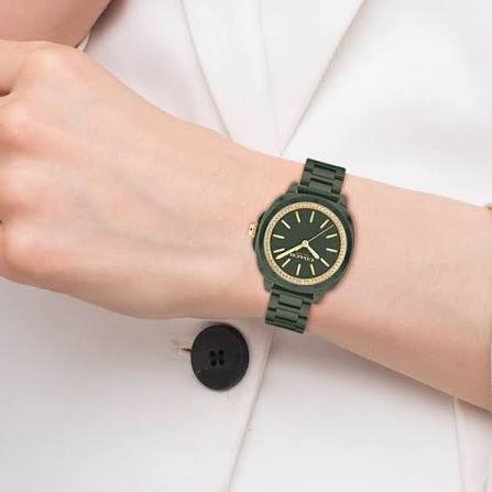 Coach Kitt green ceramic watch worn on wrist, showing black dial with gold hour markers and indices