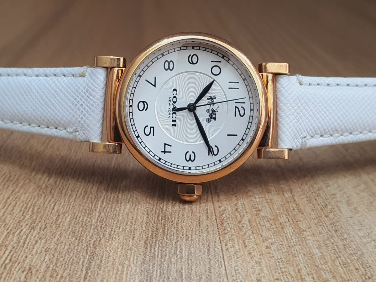 Coach Madison watch displayed on-wrist with white leather strap